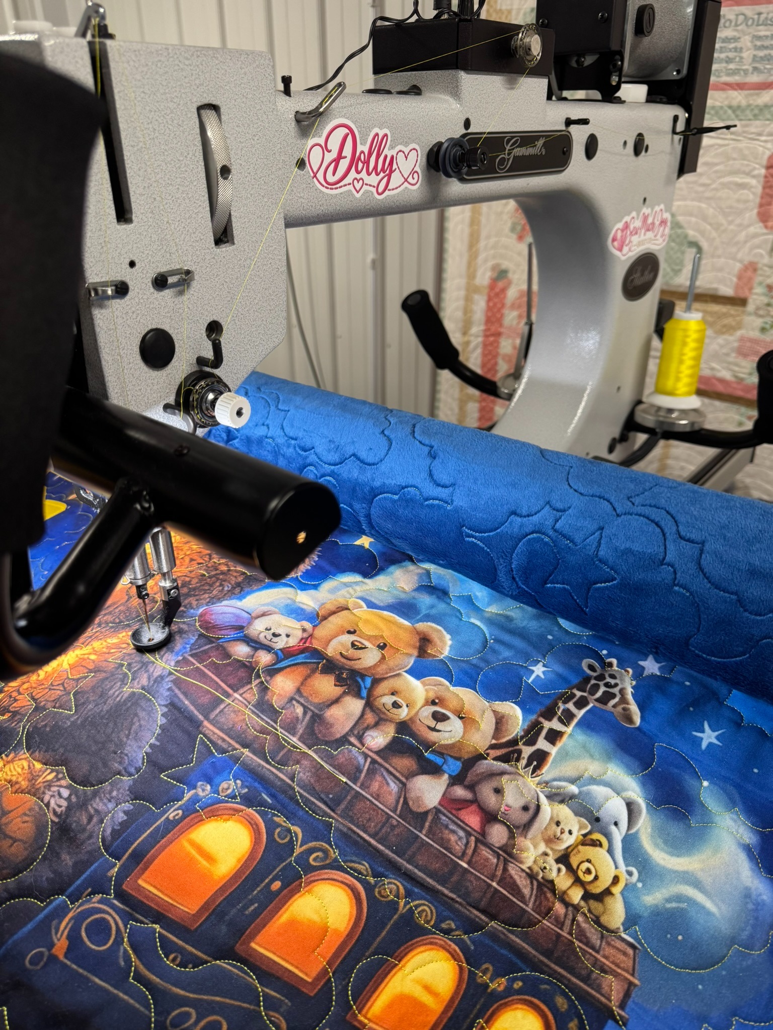 Dolly, Tina’s Gammill longarm, quilting a blue animal panel